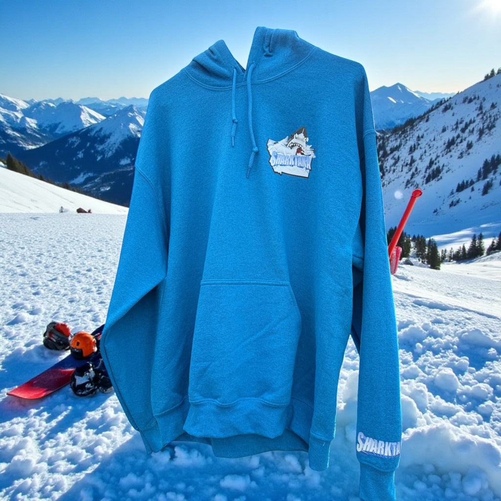 Blue hoodie with a Sharktana logo on a snowy mountain background