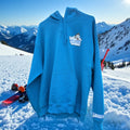 Blue hoodie with a Sharktana logo on a snowy mountain background